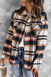 Soft plaid shacket with patch pockets in brown, black, white, and orange.
