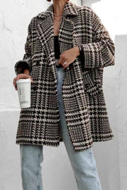 Oversized houndstooth cocoon coat in black and white with wide lapels and pockets.