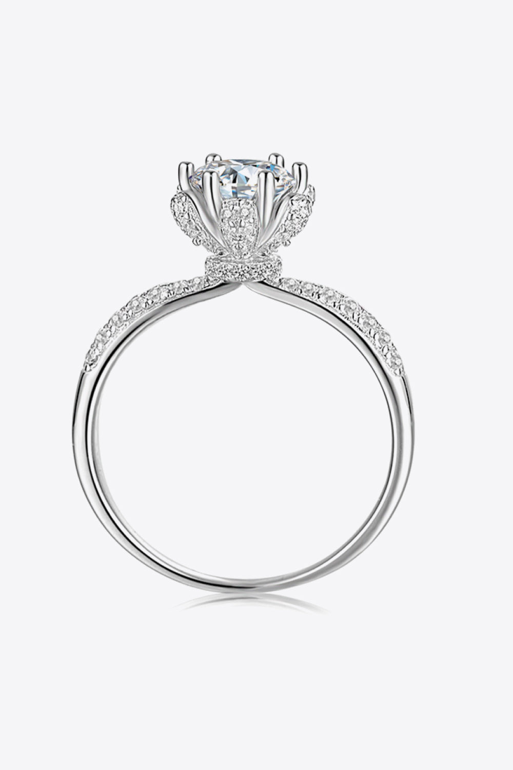 Silver halo moissanite ring with pavé band and floral-inspired setting.