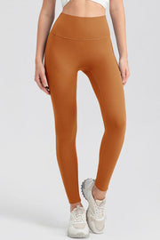 Caramel high-waist performance leggings with sculpting seams.
