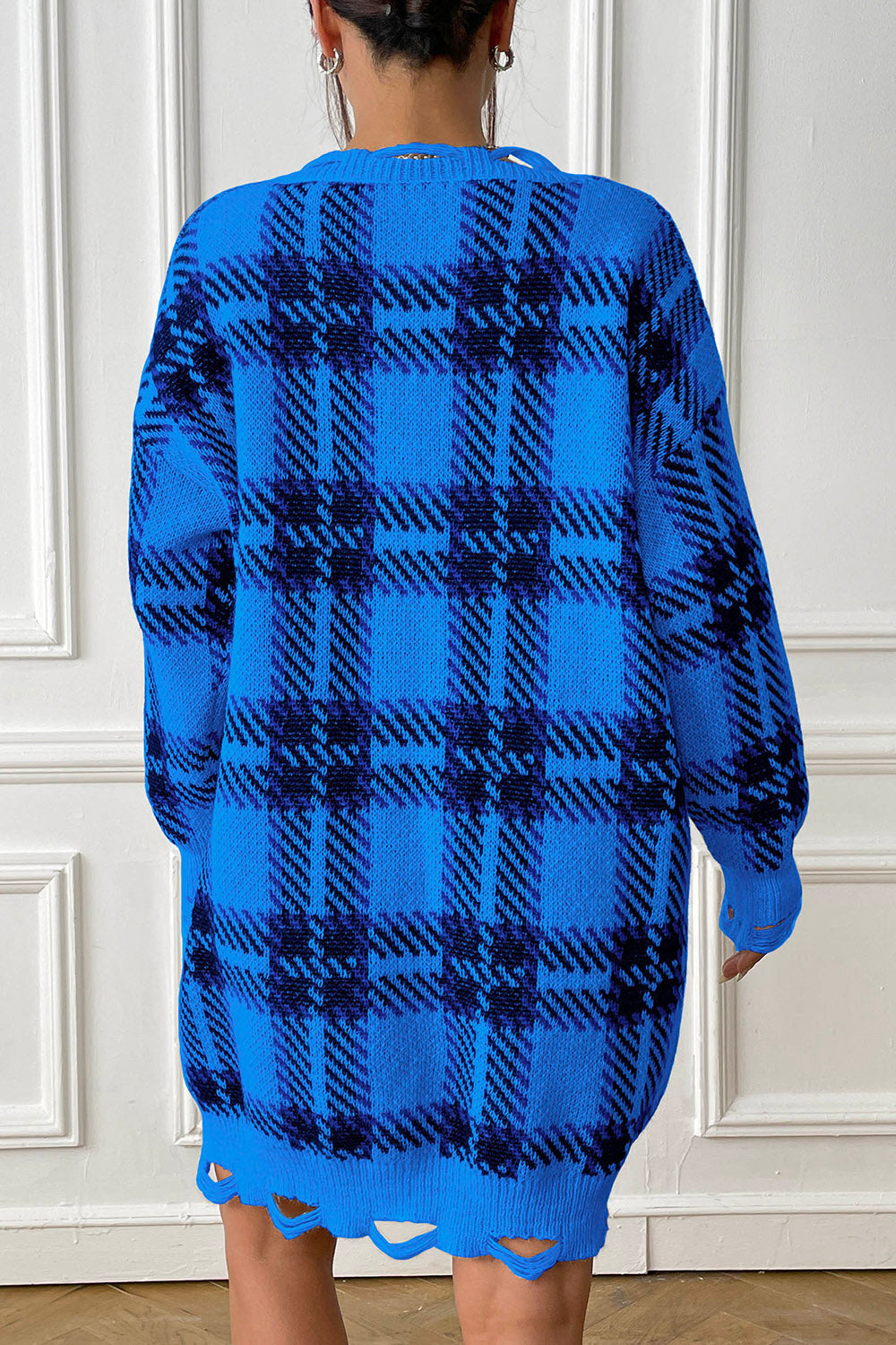Royal blue plaid knit mini dress with distressed hem and long sleeves.