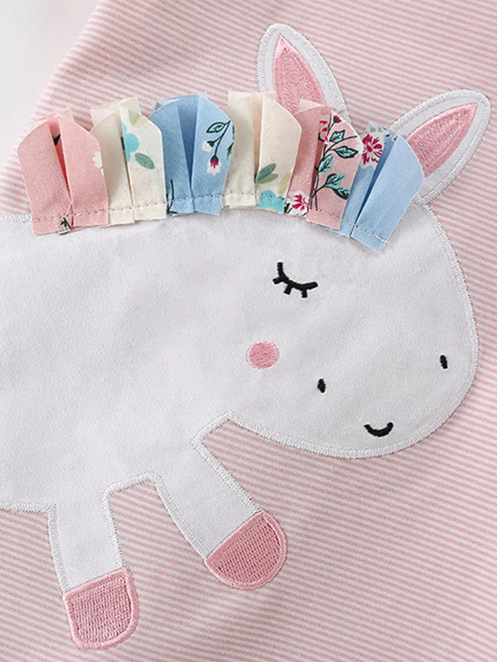 Pink striped cotton toddler top with a white unicorn applique and fabric mane.
