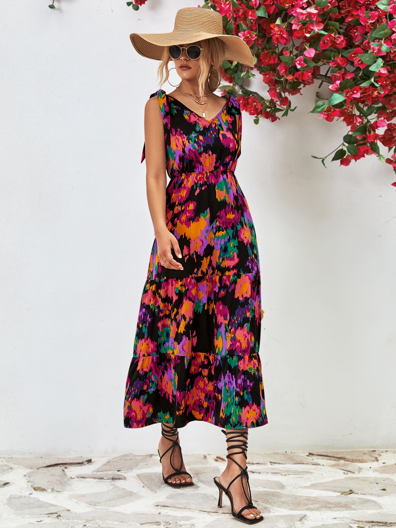 Tie-strap abstract print tiered maxi dress with V-neck and colorful pattern.