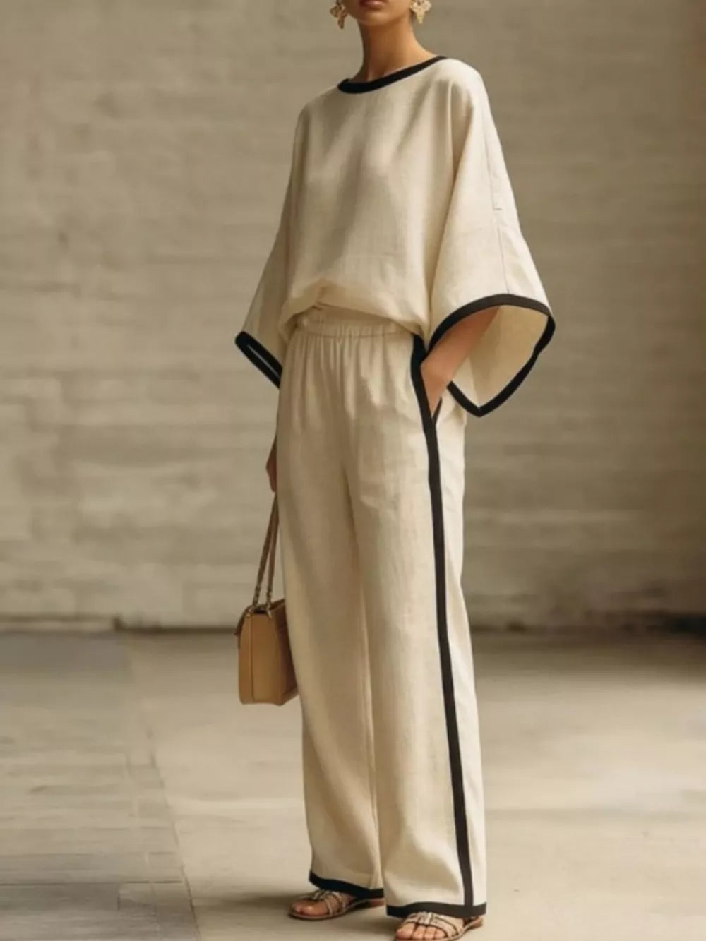 Apricot two-piece set with contrast trim on boat neck top and wide leg pants.