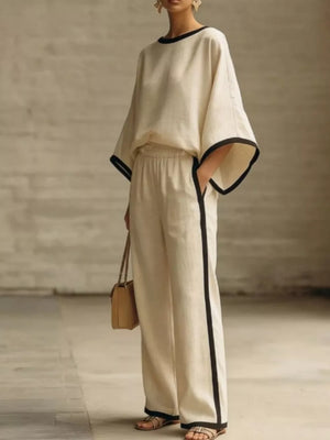 Apricot two-piece set with contrast trim on boat neck top and wide leg pants.
