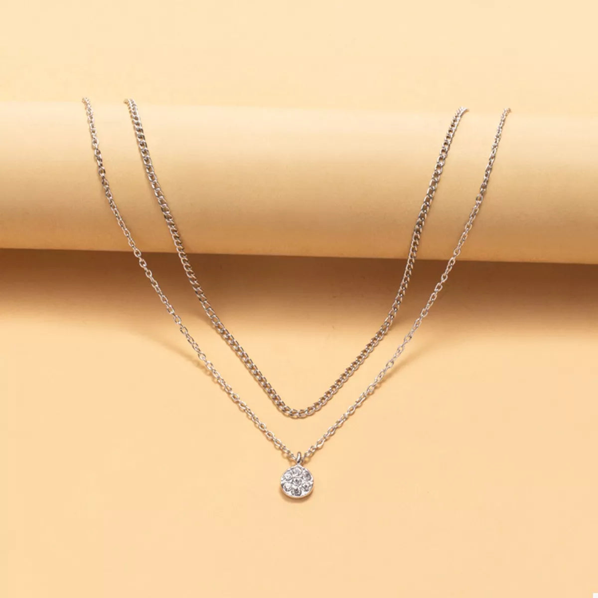 Silver double layered pendant necklace with a crystal flower charm