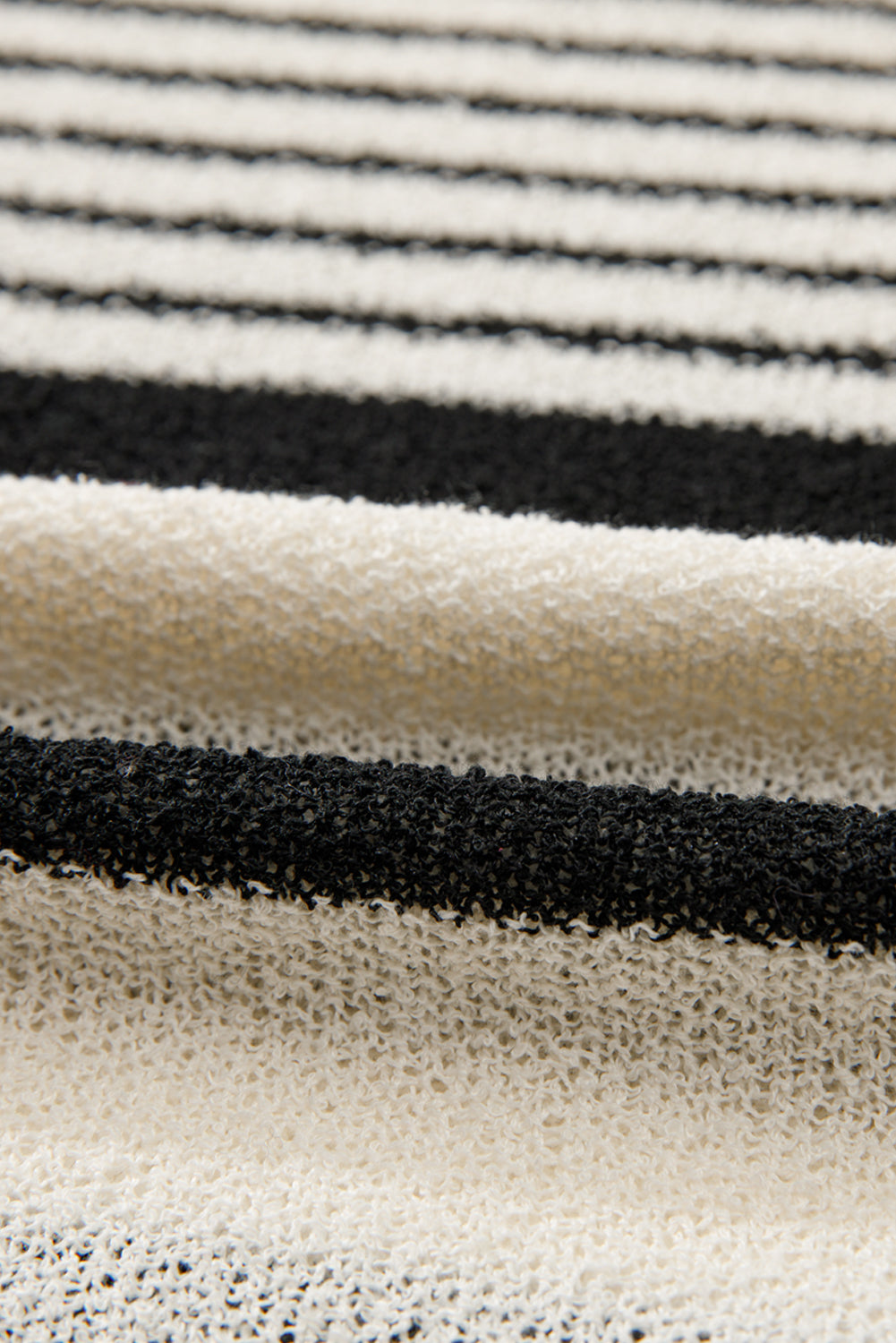 Textured black and white striped knit sleeveless top with a loose weave.