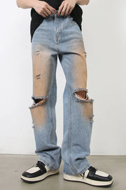 Light blue wide leg jeans with faded wash, distressed details, and ripped knees.