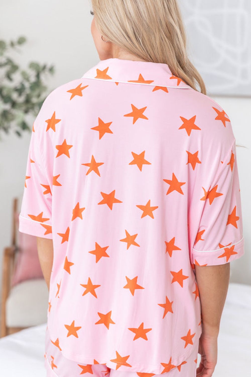 Blush pink star print pajama set with buttoned collar and short sleeves.
