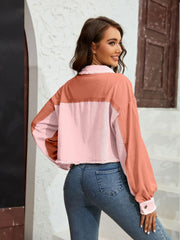 Textured colorblock cropped jacket in pink and coral with raw edges.