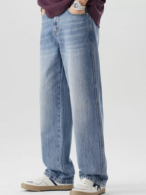 Men's relaxed fit blue washed cotton jeans with a straight leg cut.