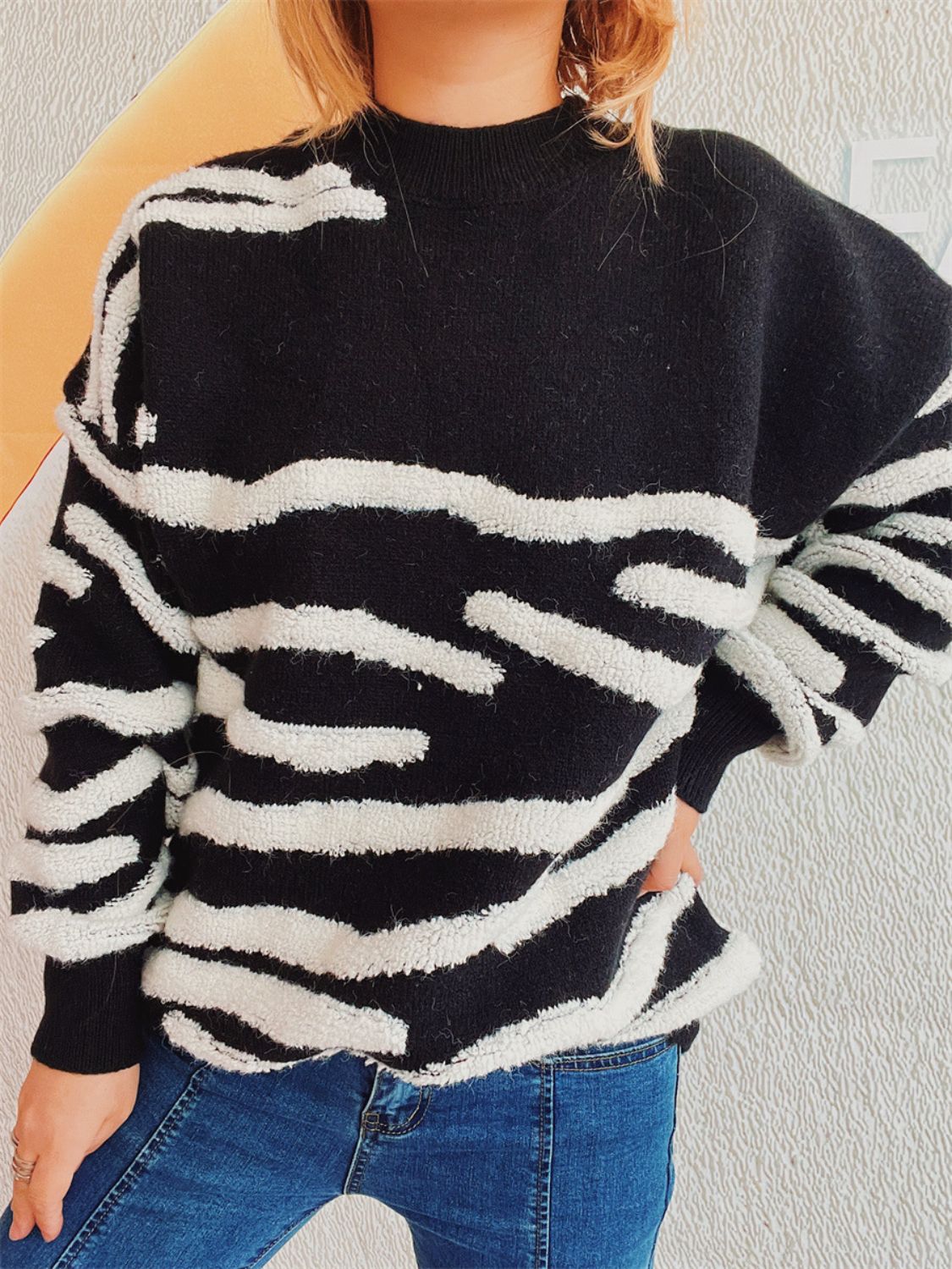 Black and white textured stripe knit crewneck sweater with a relaxed fit.