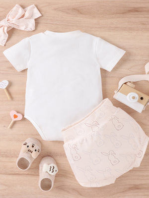 Baby set with white short sleeve bodysuit and pink bunny print shorts.