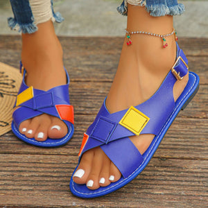 Blue criss-cross ankle strap sandals with colorful patchwork details.