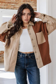 Panelled houndstooth quilted shacket in brown and beige with collared neckline and button front.