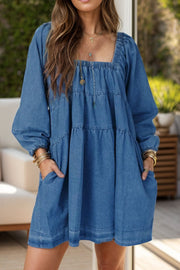 Tiered denim mini dress with square neck and long sleeves in medium wash.