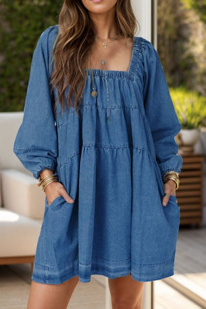 Tiered denim mini dress with square neck and long sleeves in medium wash.