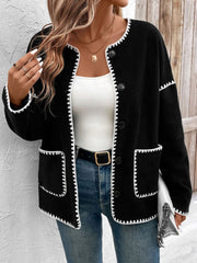 Black knit jacket with white scalloped trim and button front.