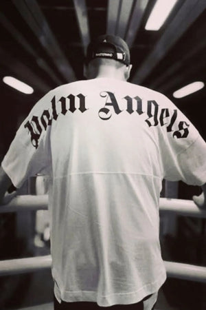 White oversized tee with black gothic logo print on back