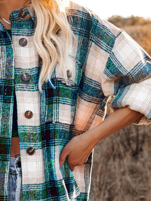 Plaid pocket long sleeve shirt jacket in dark green and black with button details.