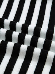 Colorblock striped knit sweater with crew neck and soft texture.
