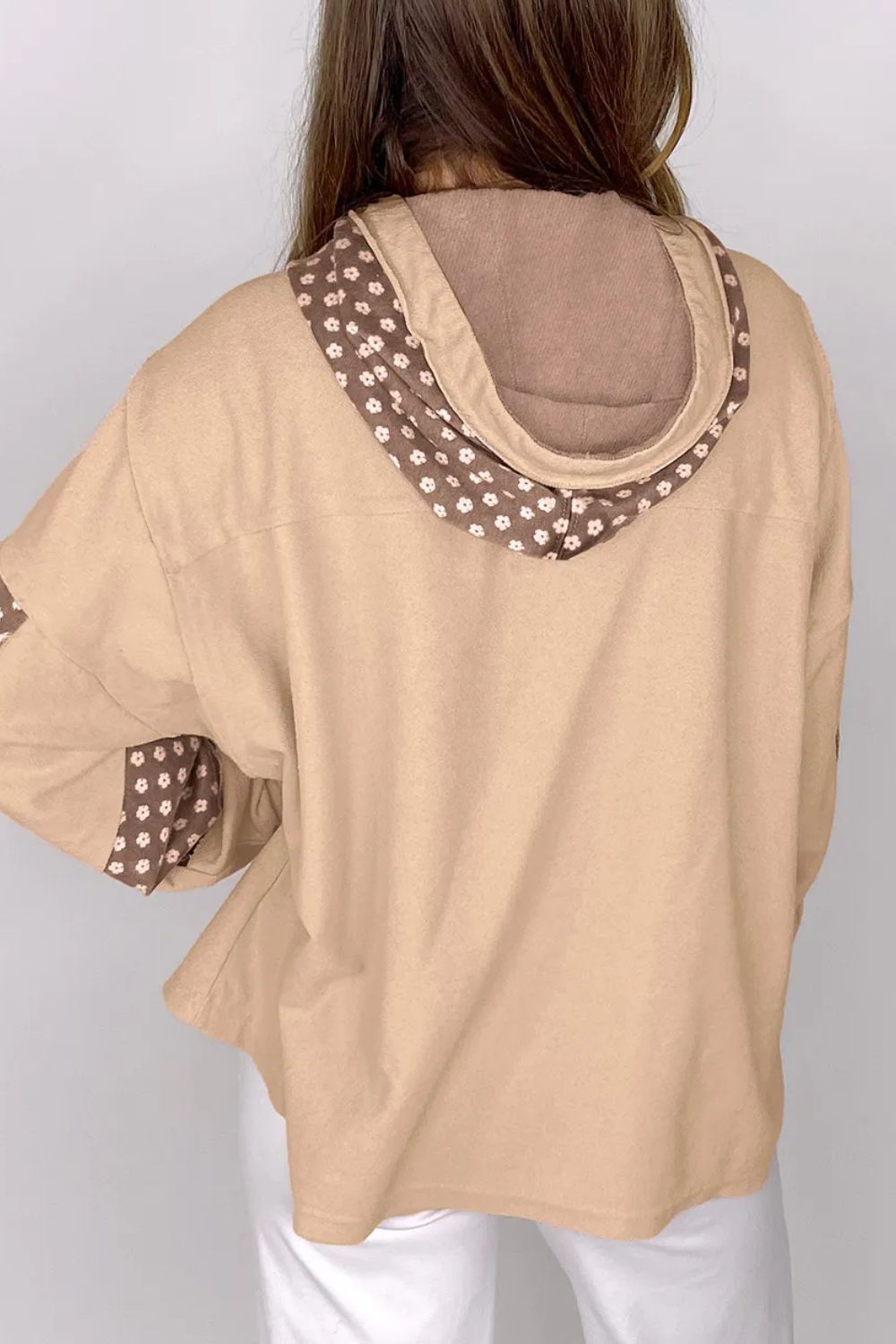 Tan hoodie with floral patchwork on the hood lining and sleeves.