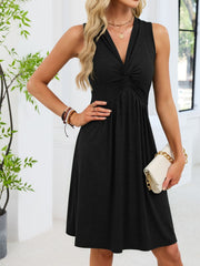 Black sleeveless casual dress with twist knot front and A-line skirt.