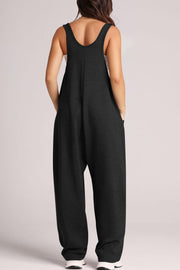 Black relaxed fit jumpsuit with oversized pockets and scoop neckline.