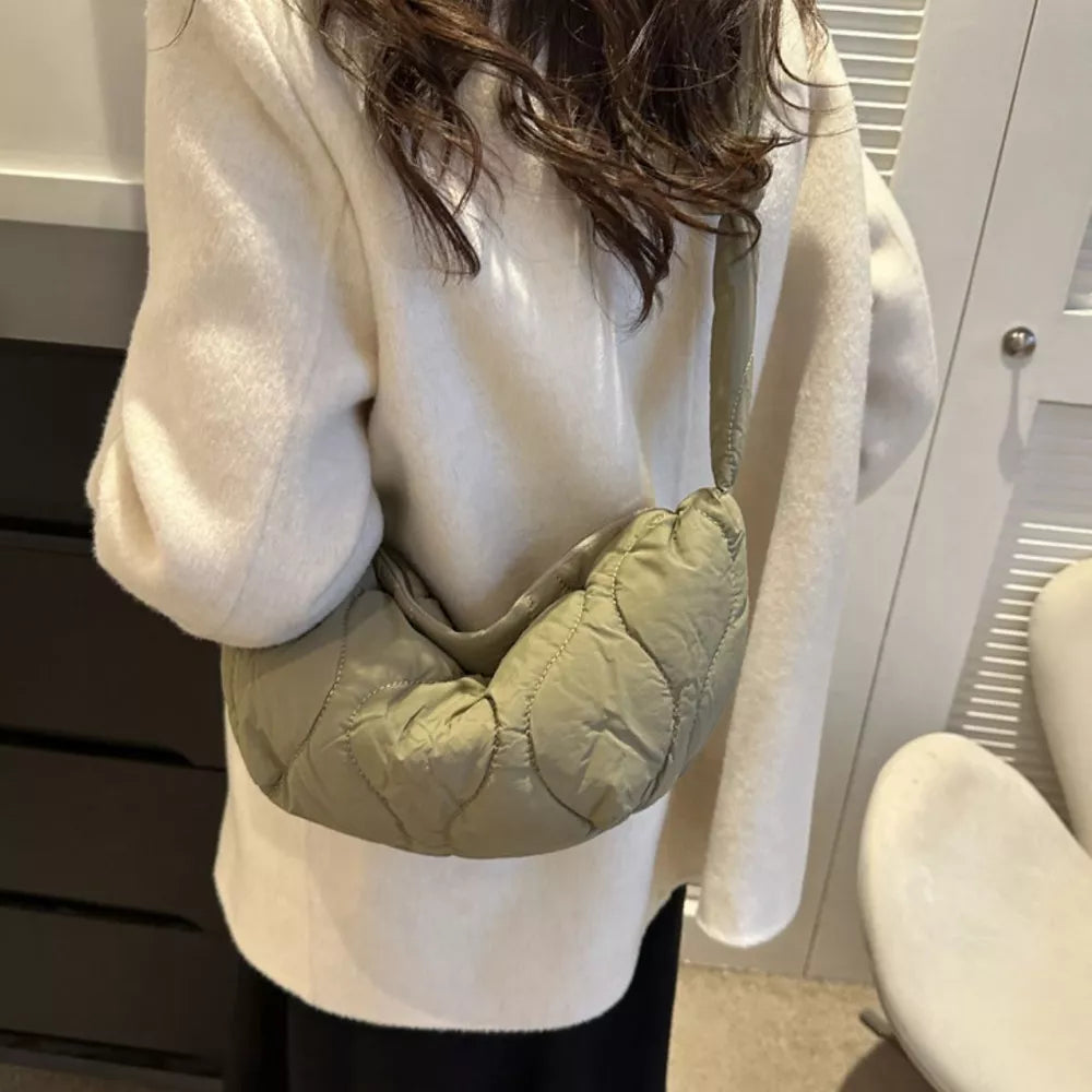 Puffy quilted crossbody bag in army green with abstract pattern and knotted strap.