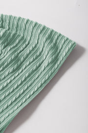 Textured cable knit sweater in Gum Leaf green with flutter sleeves.
