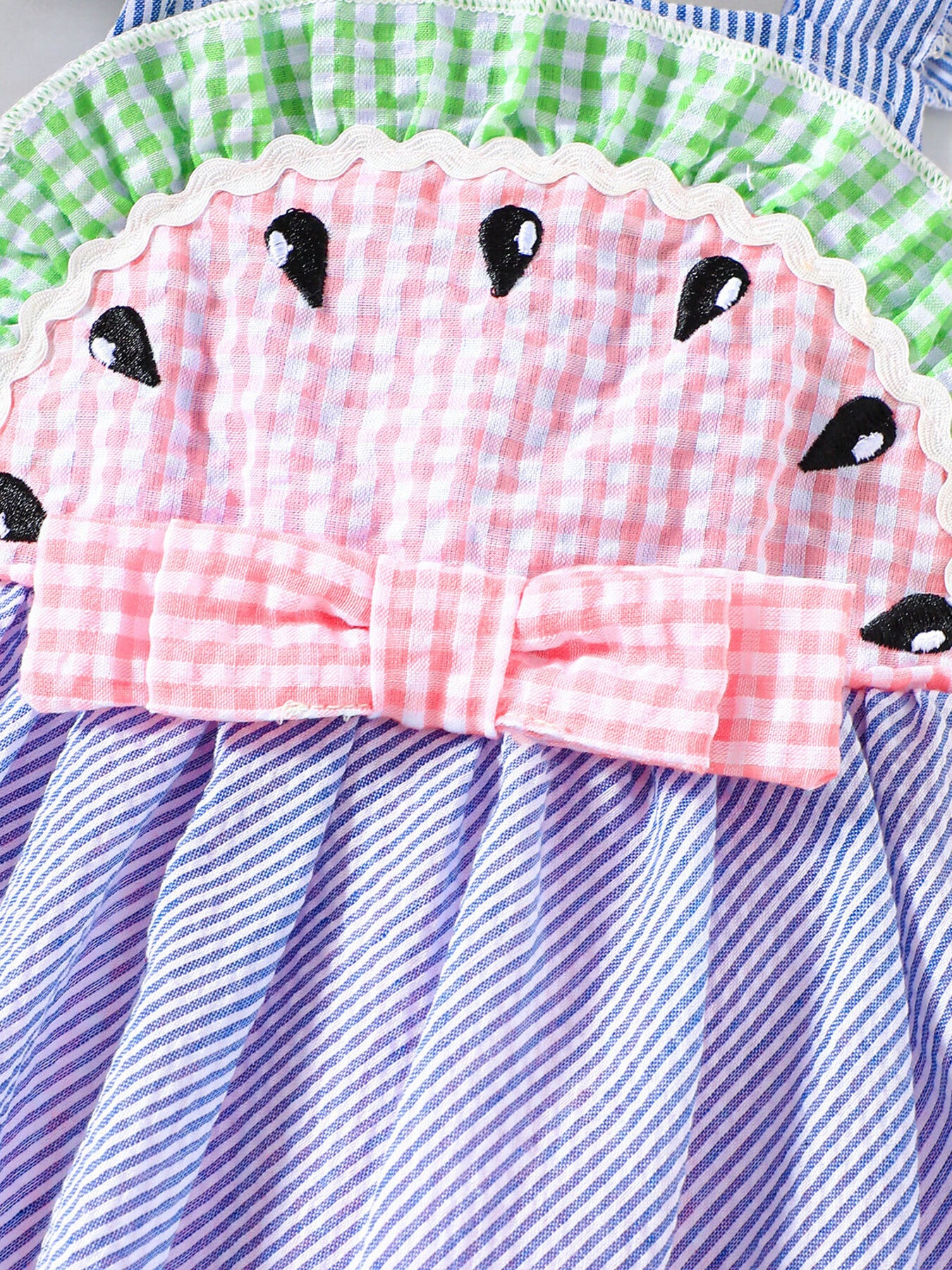 Baby dress with watermelon design, pink gingham, bow, and blue striped skirt.
