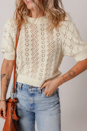 Cream lace-effect knit top with puff sleeves and diamond pattern detail
