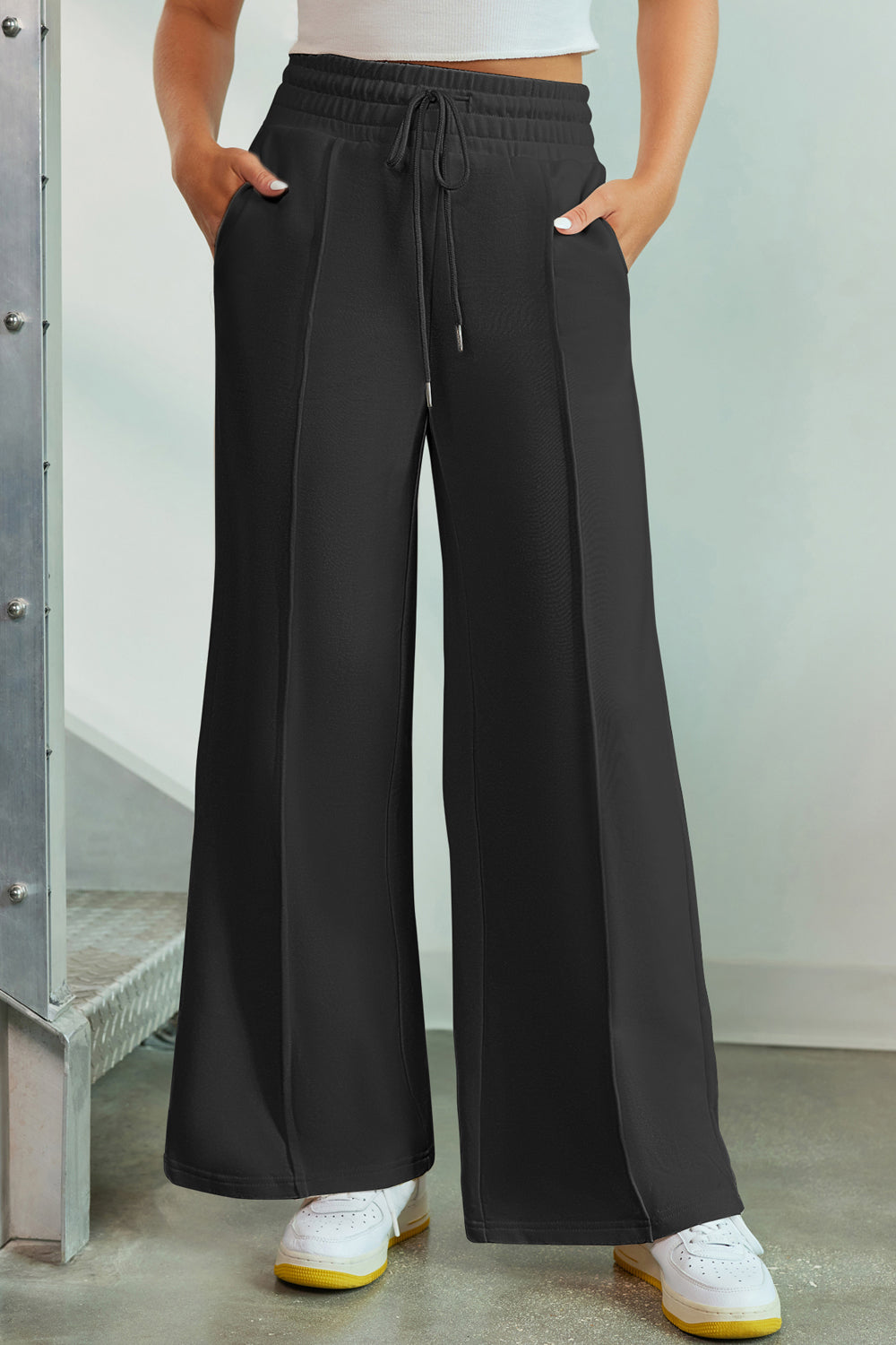 Black palazzo joggers with center seam detail and drawstring waist.