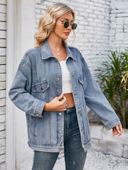 Oversized denim trucker jacket in dusty blue with rolled sleeves and button details.