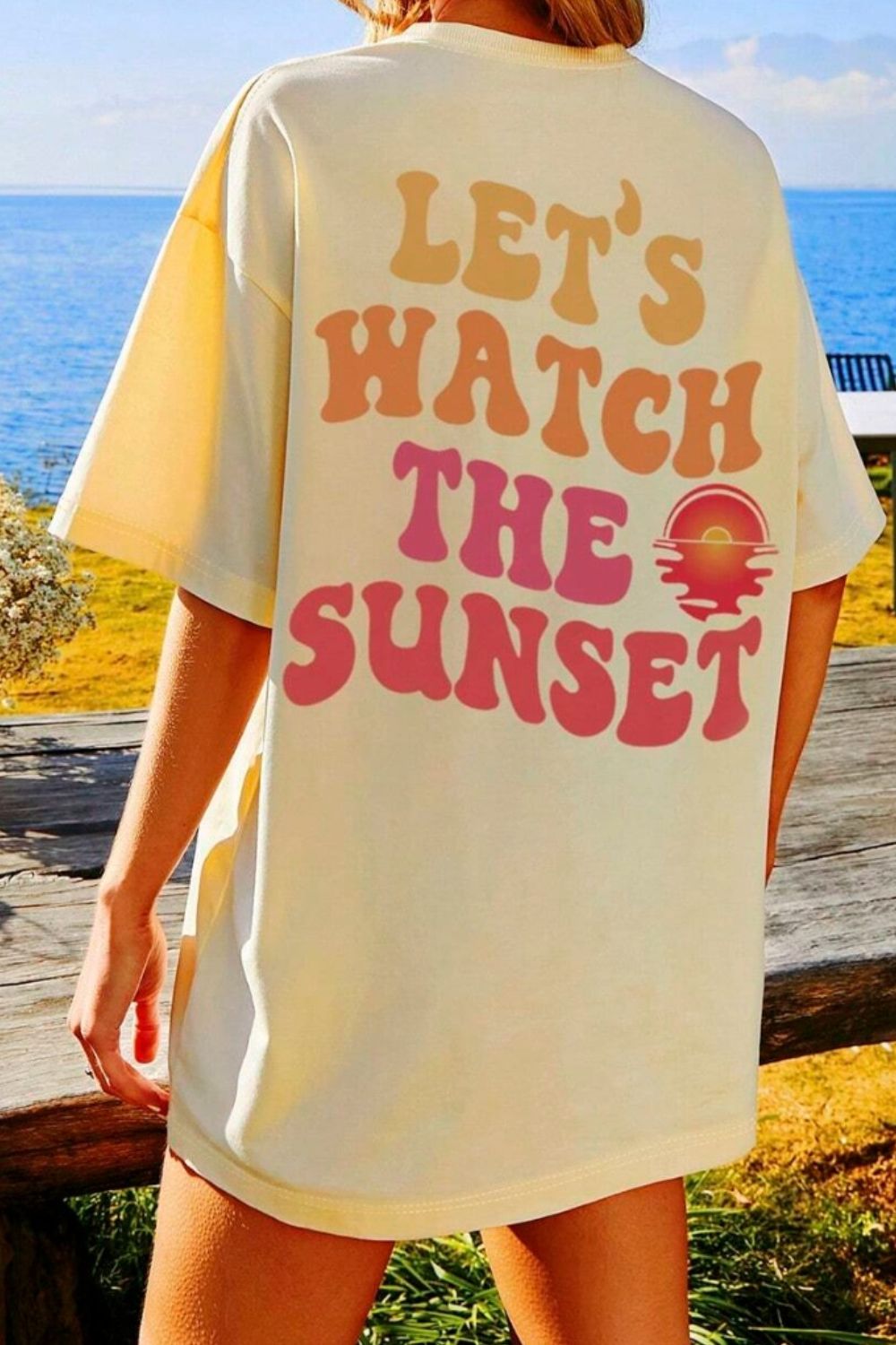 Oversized khaki t-shirt with "Let's Watch The Sunset" graphic and sunset graphic.