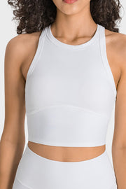 White activewear crop top with sculpted neckline and racerback straps.