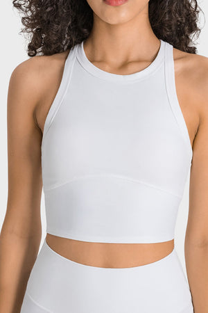 White activewear crop top with sculpted neckline and racerback straps.