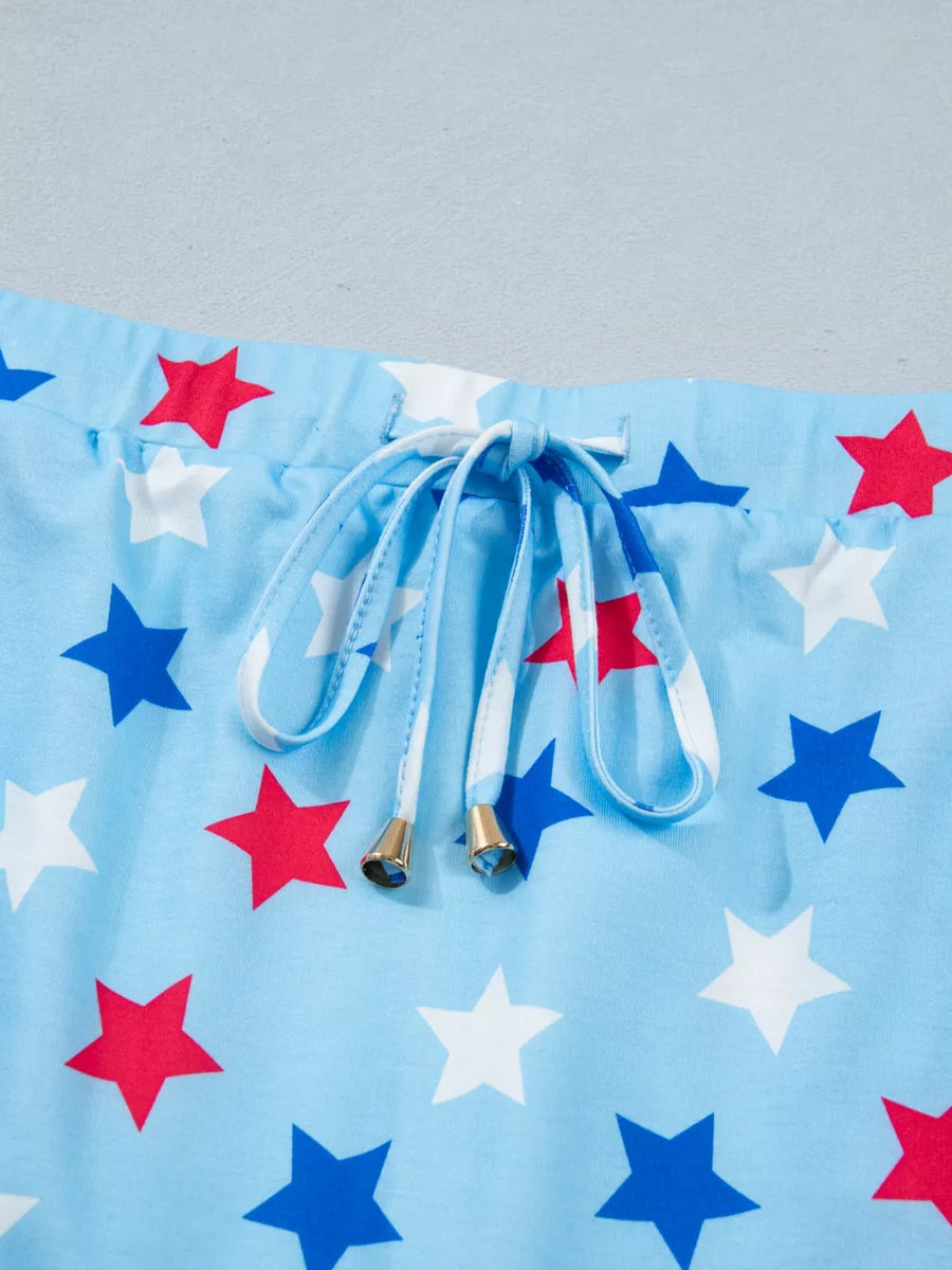 Light blue drawstring skort with white, red, and blue stars and gold-tipped drawstrings.