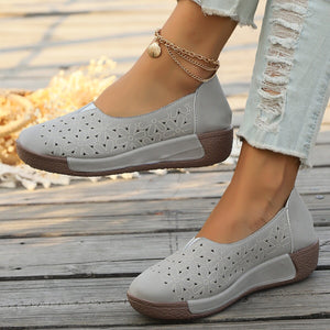 Grey floral cutout slip-on loafers with a comfortable wedge sole.