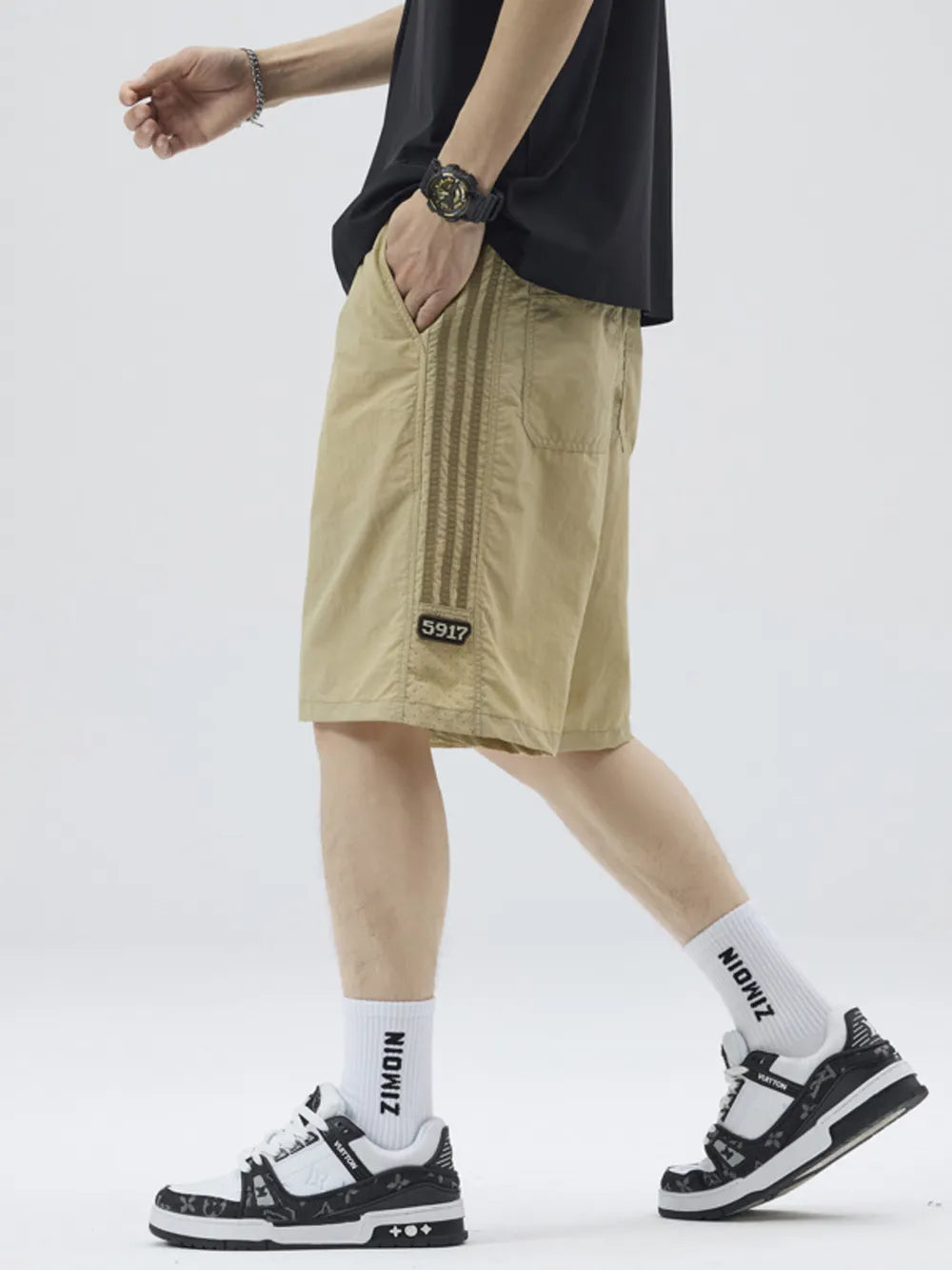 Khaki casual drawstring shorts with sporty side stripes and a number patch.