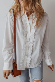 White cotton shirt with eyelet ruffle front detail and button closure.