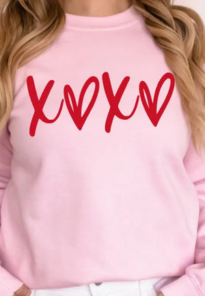 Blush pink sweatshirt with red XOXO graphic print, relaxed fit, crew neck.