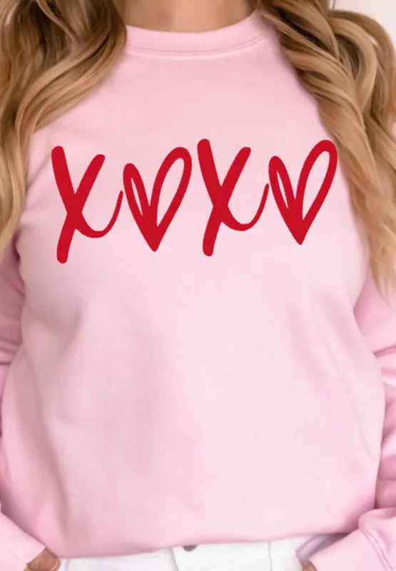 Blush pink sweatshirt with red XOXO graphic print, relaxed fit, crew neck.