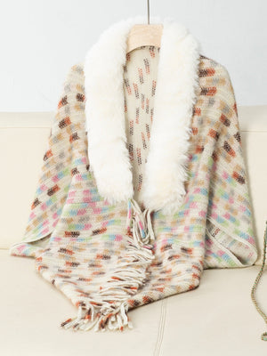 Textured plaid acrylic poncho with cream faux fur collar and fringe detail.