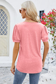 Watermelon pink tee with puff sleeves and ruffled placket detail.