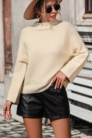 Ribbed mock neck sweater in tan with volume sleeves and a relaxed fit.