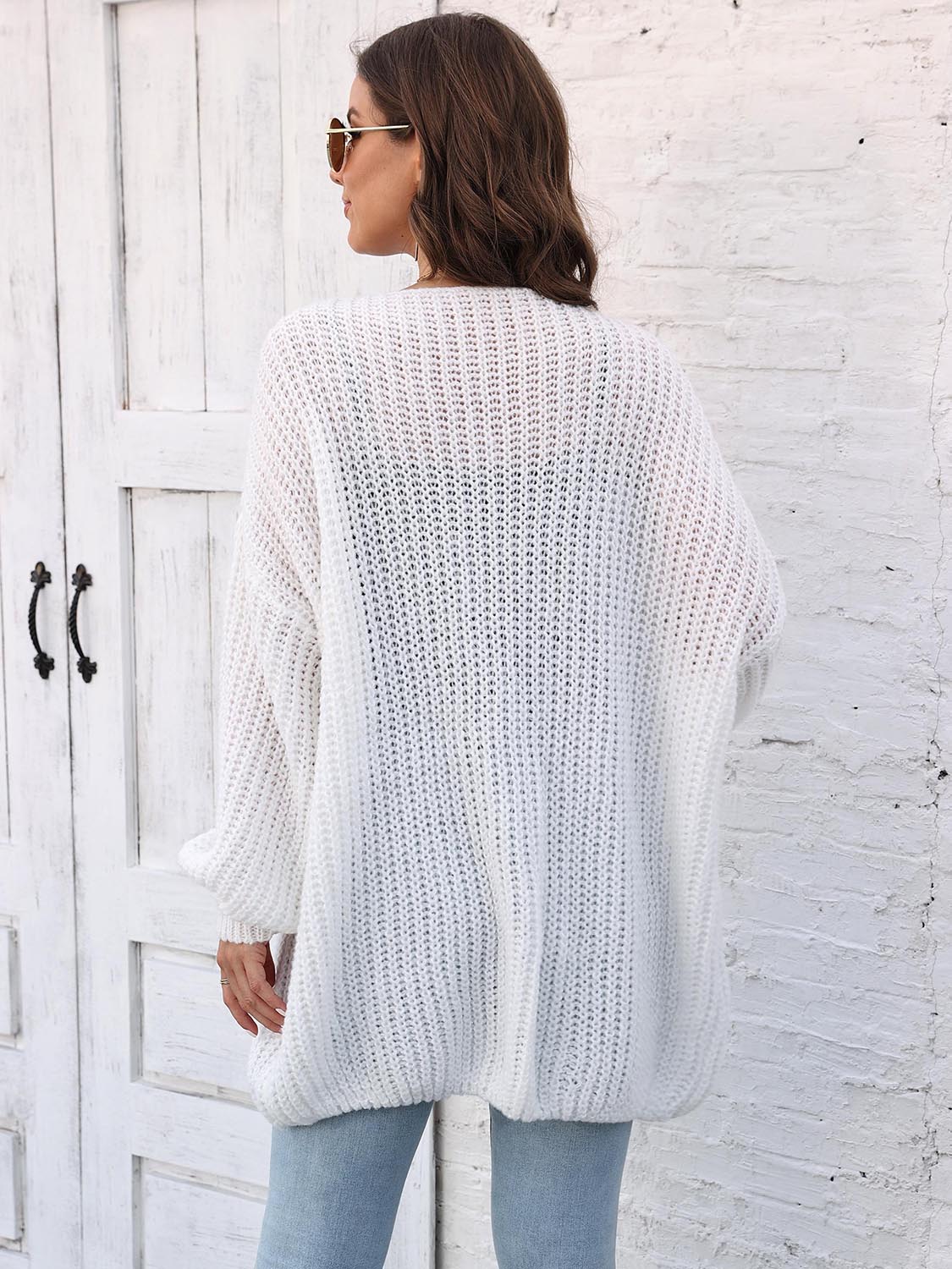 White open knit cardigan with balloon sleeves and a relaxed fit.