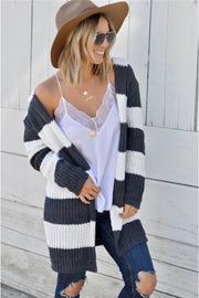 Chunky knit hooded cardigan with wide gray and white stripes, open front, and long sleeves.