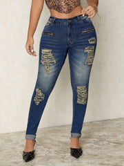 Distressed skinny jeans in dark wash denim with zip details and ripped accents.