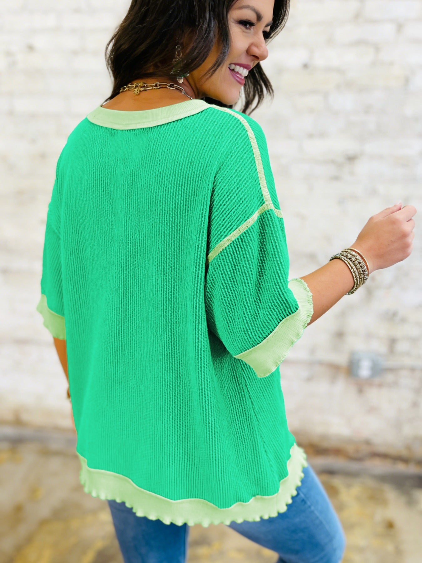Twist ribbed t-shirt in bright green with contrast stitching and asymmetrical hem.